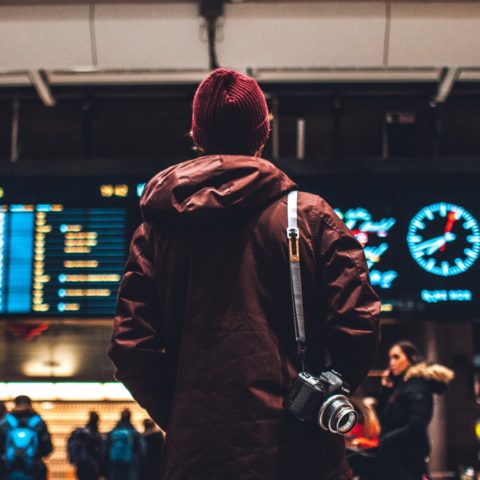 person looking up to the flight schedules