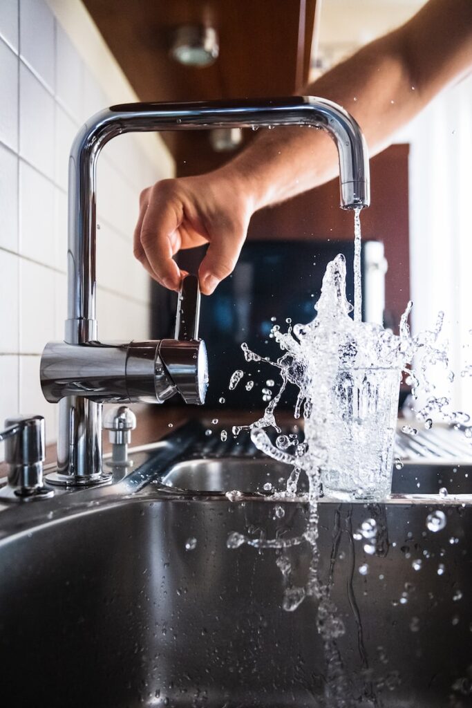 person opening faucet