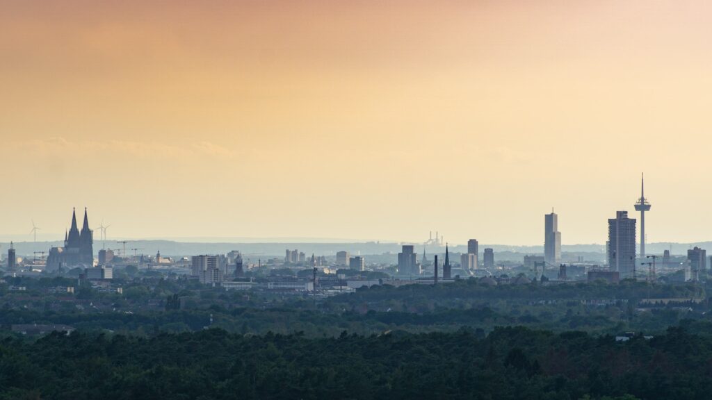 city skyline under orange sky during daytime