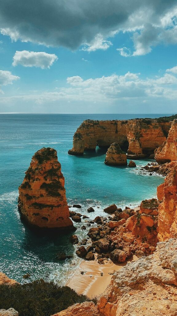 Expats enjoying the golden sands of the Algarve coast, a popular destination for those relocating to Portugal for its climate and natural beauty.