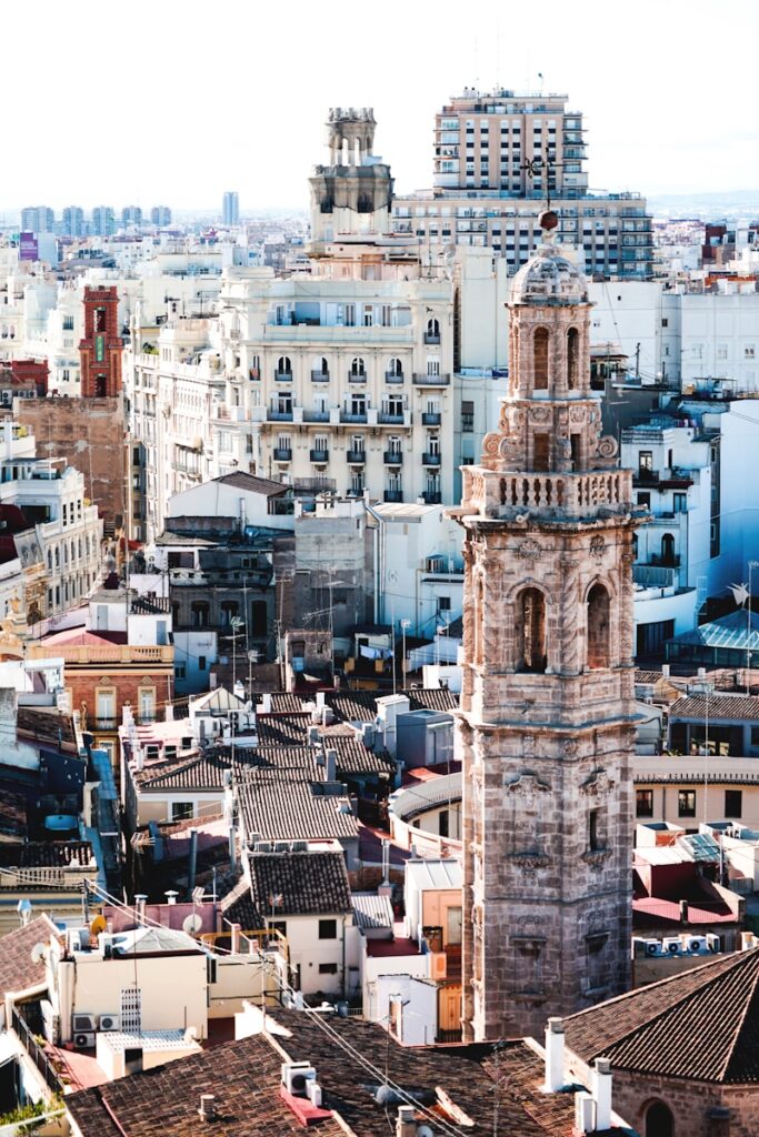 aerial photography of beige tower surrounded by houses during daytime