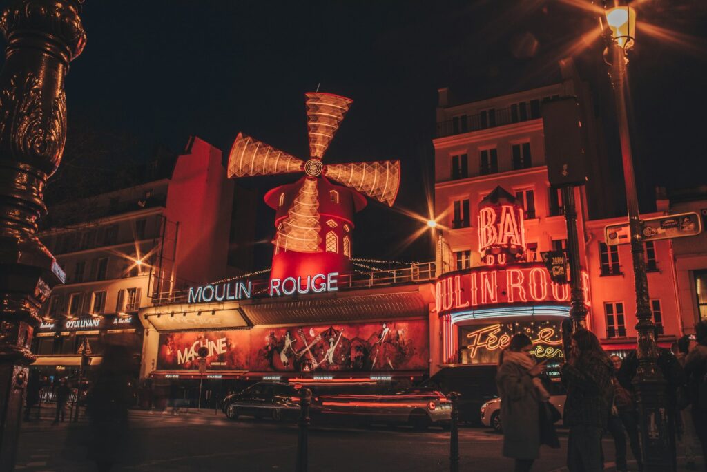 Night time view of the Moulin Rouge in Pigalle, a student-friendly neighborhood in Paris