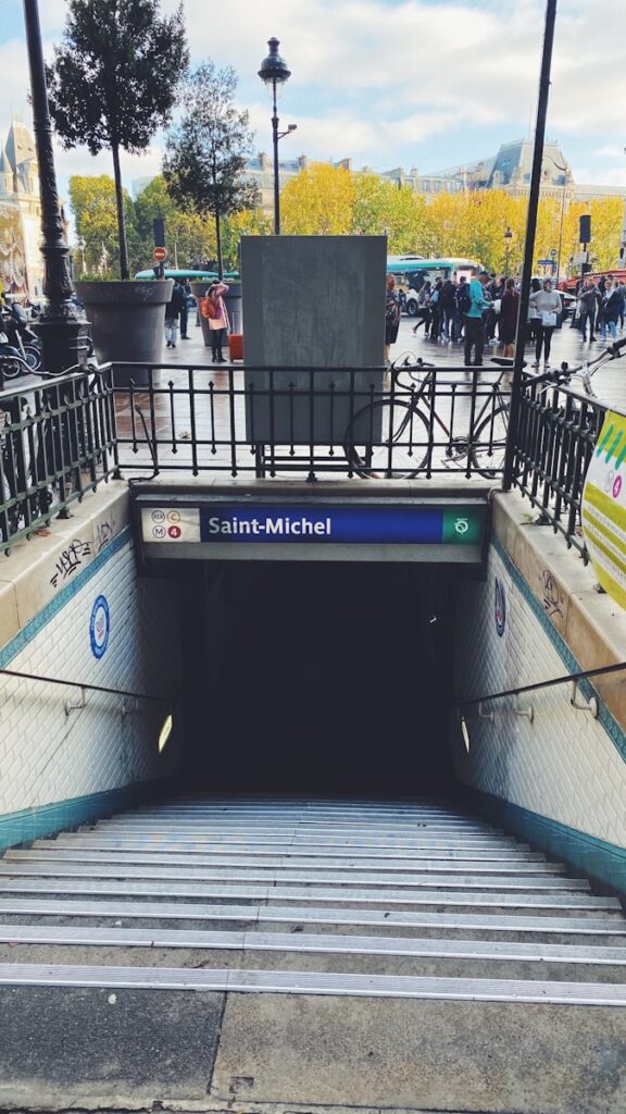 The entrance to the Saint Michel Metro station in Paris. The Paris Metro is a crucial part of the city's public transportation network, smoothly connecting its neighborhoods and landmarks